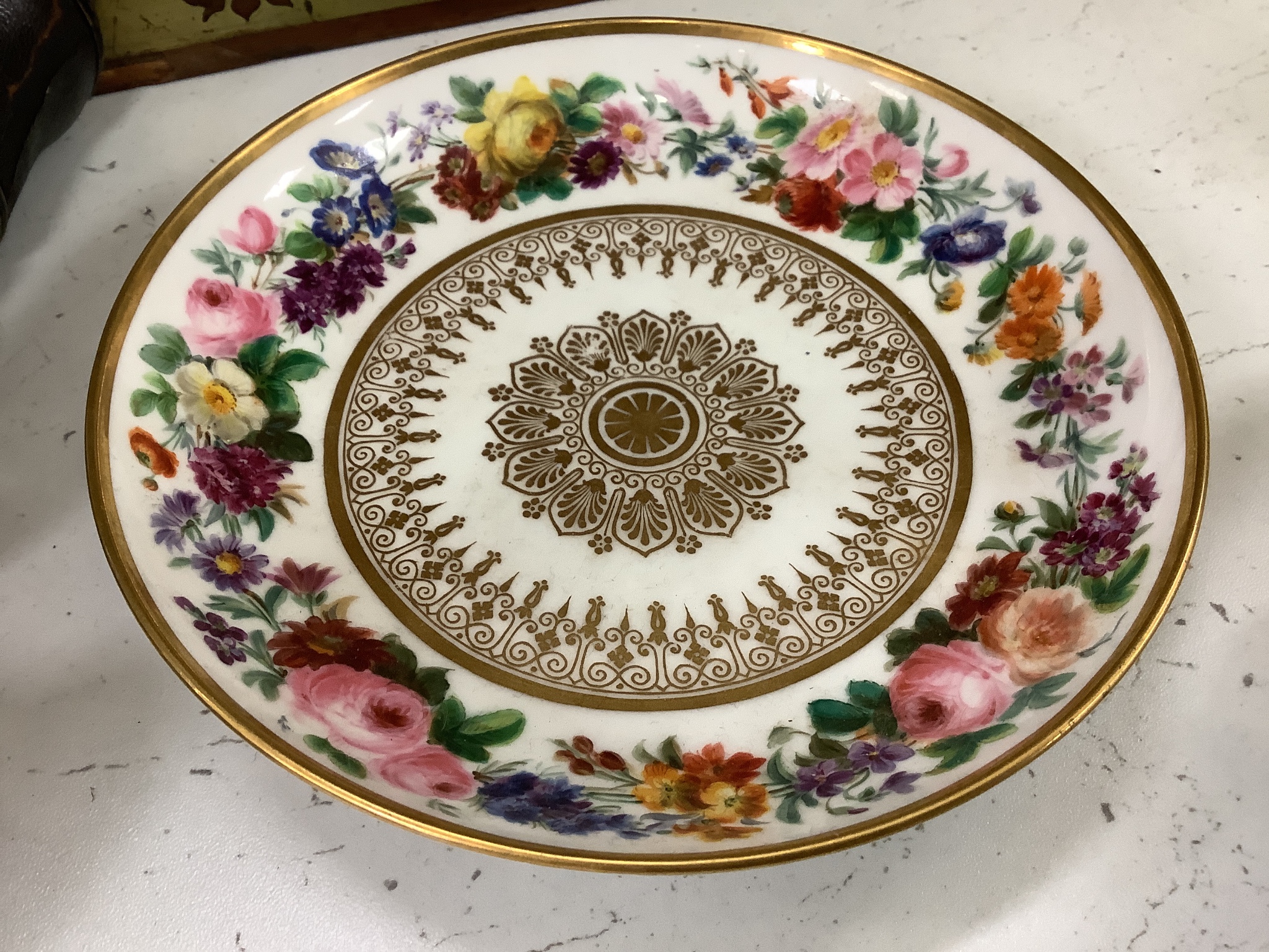 A Sevres circular dish finely painted with flowers and intricately gilded, blue mark, 1850's and a Rue Thiroux or Fabrique de la reine porcelain plate with Queen Marie Antoinette' mark of Crown over A stencilled in red,